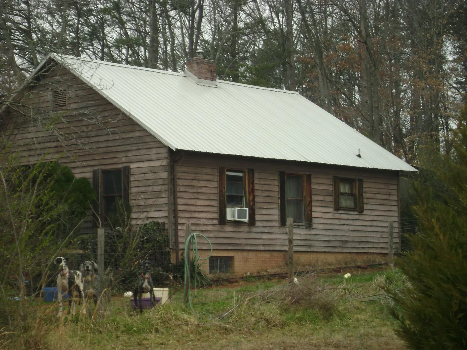 White metal roof on an old wood sided farmhouse, from a Metal Roof Installation job in Blue Rock